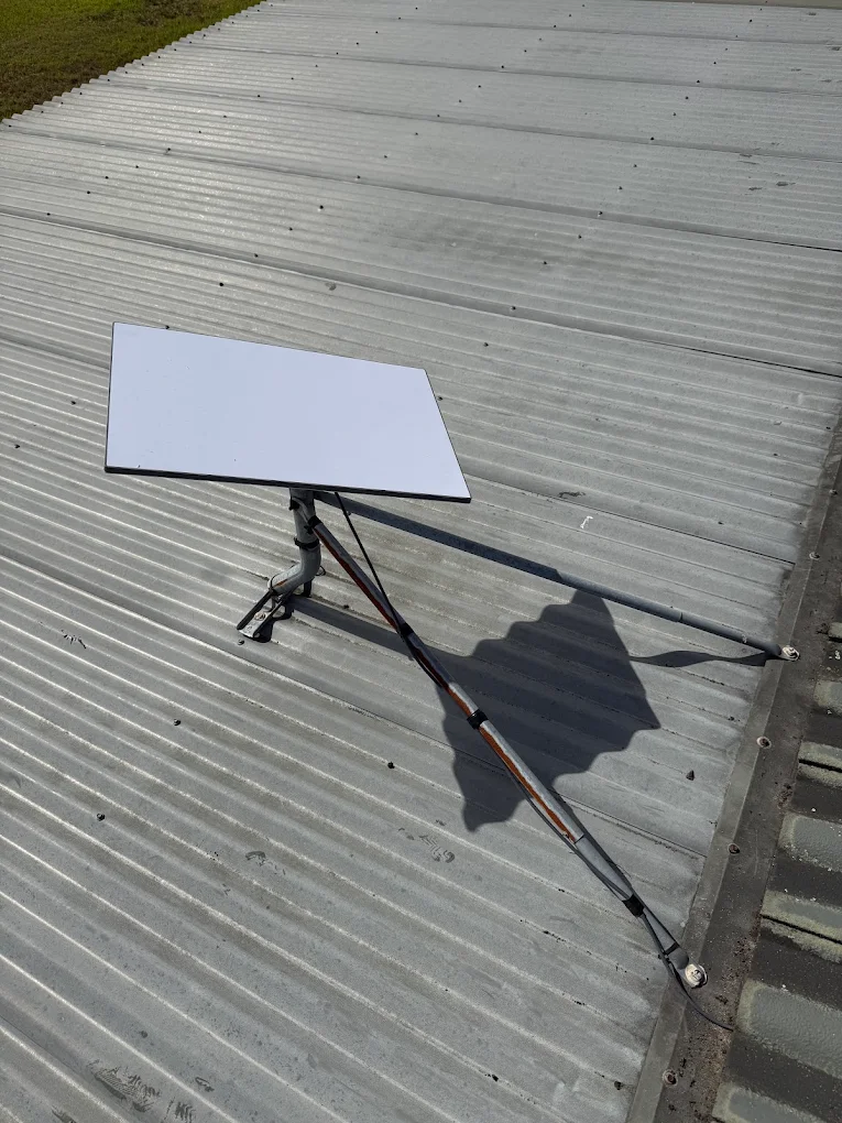 Satellite dish installed on a metal residential roof